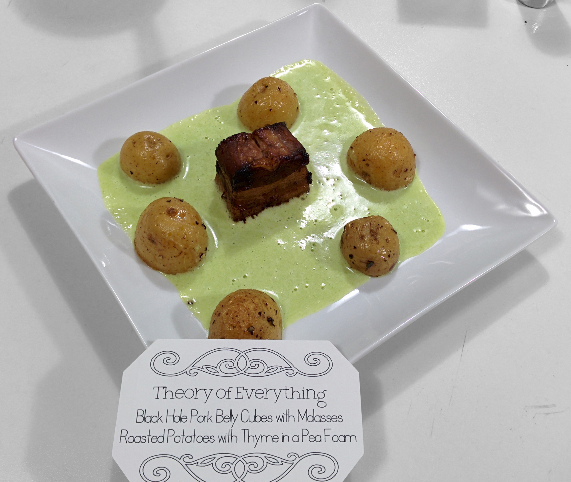 The Theory of Everything: Black hole pork belly cubes with molasses, roasted potatoes with thyme in pea foam